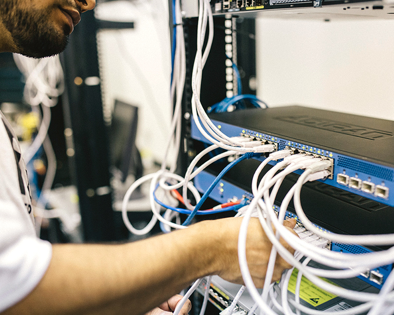 Technician adjusting cables on a server